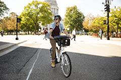 Electric Bike Rider in Madison against the Wisconsin State Capitol